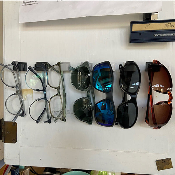eight sunglasses hanging in cabinet
