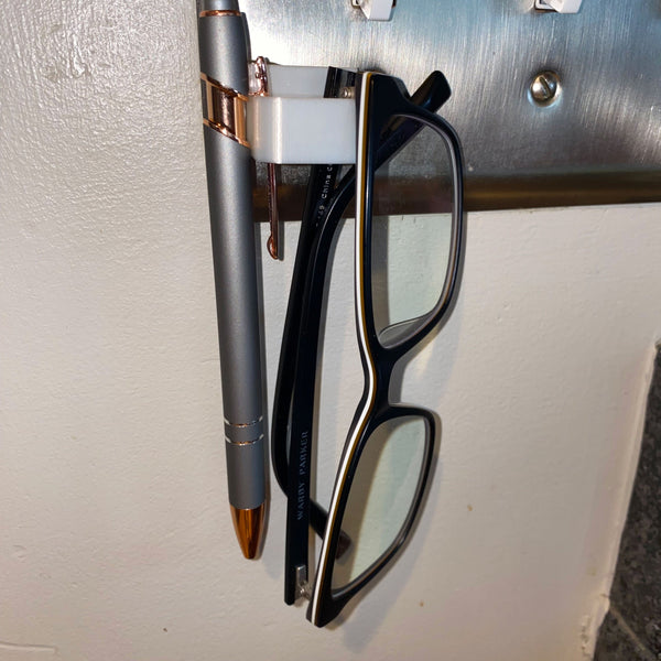 glasses keep on light switch plate and pen
