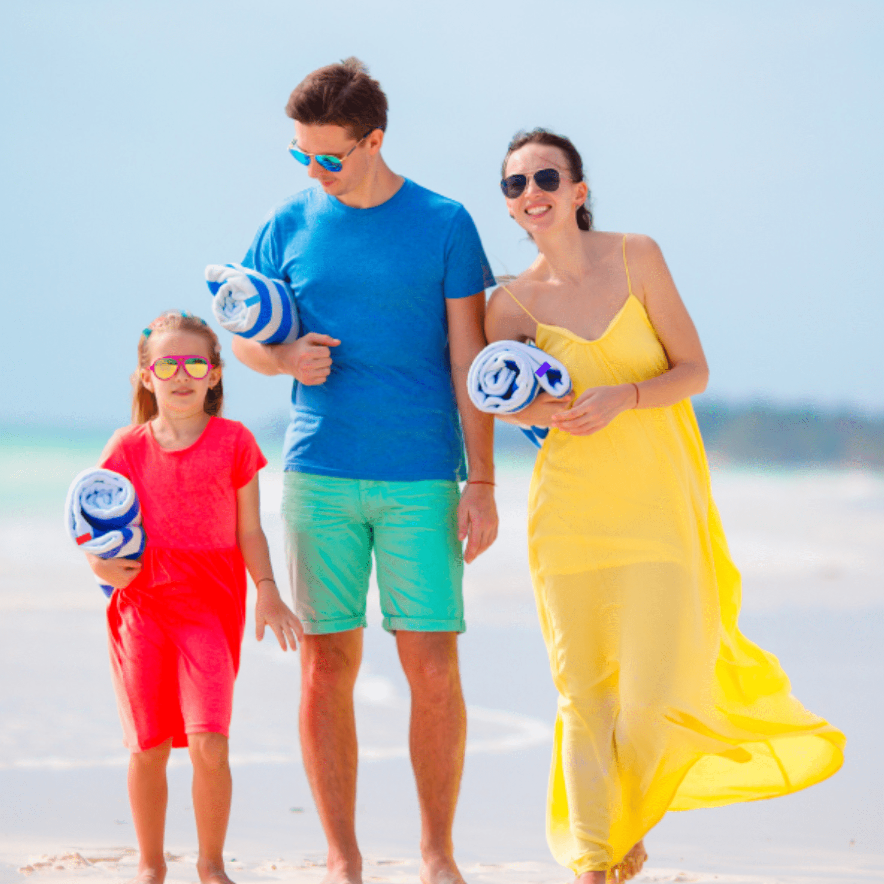walking the beach with towels and towel keep